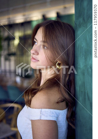 a 16-year-old teenage girl in old money style clothes in  fancy restaurant 117959370