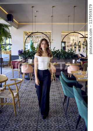 a 16-year-old teenage girl in old money style clothes in  fancy restaurant 117959379