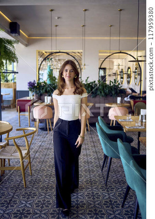 a 16-year-old teenage girl in old money style clothes in  fancy restaurant 117959380