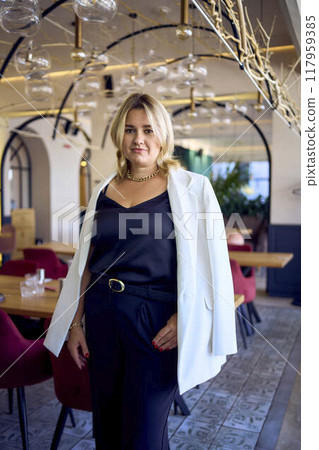 a portrait of middle-aged plus size woman in old money style clothes in a fancy restaurant a portrait of middle-aged plus size woman in old money style clothes in a fancy restaurant 117959385