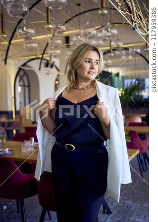 a portrait of middle-aged plus size woman in old money style clothes in a fancy restaurant a portrait of middle-aged plus size woman in old money style clothes in a fancy restaurant 117959386