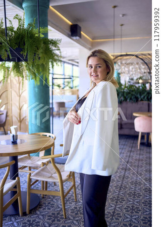 a portrait of middle-aged plus size woman in old money style clothes in a fancy restaurant a portrait of middle-aged plus size woman in old money style clothes in a fancy restaurant 117959392