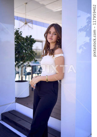 a    portrait of  16-year-old teenage girl in old money style clothes in  fancy restaurant 117959402