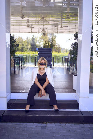 a portrait of middle-aged plus size woman in old money style clothes in a fancy restaurant a portrait of middle-aged plus size woman in old money style clothes in a fancy restaurant 117959528