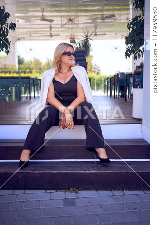 a       portrait of  middle-aged plus size woman in old money style clothes in a fancy restaurant 117959530
