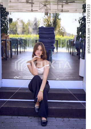 a    portrait of  16-year-old teenage girl in old money style clothes in  fancy restaurant 117959533