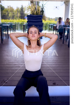 a    portrait of  16-year-old teenage girl in old money style clothes in  fancy restaurant 117959541