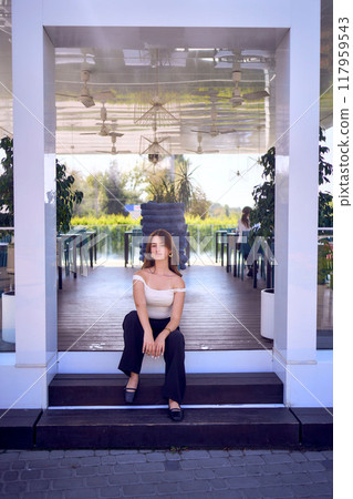 a    portrait of  16-year-old teenage girl in old money style clothes in  fancy restaurant 117959543