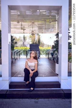 a    portrait of  16-year-old teenage girl in old money style clothes in  fancy restaurant 117959544
