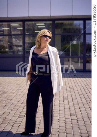 a       portrait of  middle-aged plus size woman in old money style clothes in a fancy restaurant 117959556