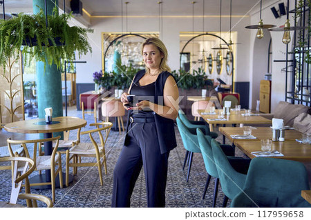 a   middle-aged plus size woman in old money style clothes in a fancy restaurant 117959658