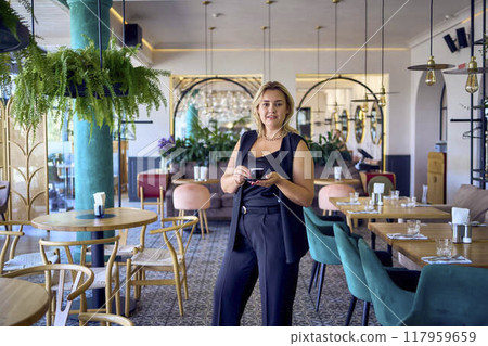 a   middle-aged plus size woman in old money style clothes in a fancy restaurant 117959659