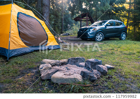 Camping Scene with SUV and Yellow Tent Camping Scene with SUV and Yellow Tent 117959982