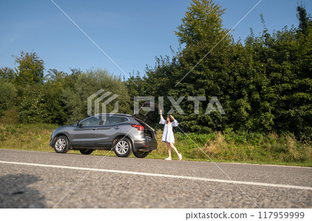 Woman Relaxing on SUV in Nature 117959999