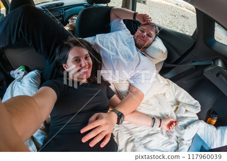 Couple Watching Movie in Car by the River 117960039