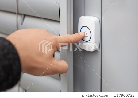 Wireless Doorbell Mounted on Brick Wall 117960722