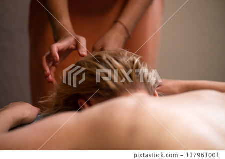 Head massage. Masseuse, client and scalp care, headache treatment and physiotherapy for healing 117961001