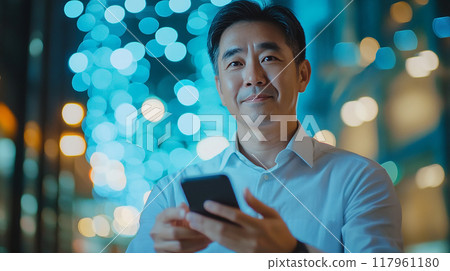 A man operating a smartphone in the night view A man operating a smartphone in the night view 117961180