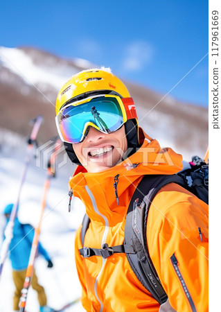 A man in a yellow jacket is smiling and posing for a photo while wearing goggles A man in a yellow jacket is smiling and posing for a photo while wearing goggles 117961669