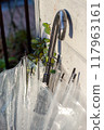 An umbrella propped up next to the entrance after the rain. 117963161