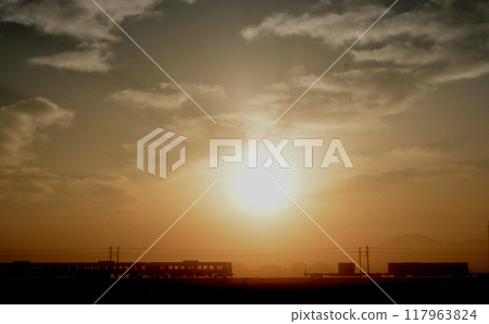 A train running during the morning glow. 117963824