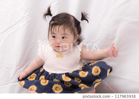 [Sitting baby with twin tails] 117963938