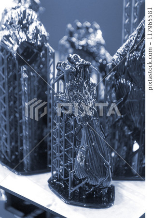 Model of hand printed on a 3D printer from black rubber, close-up. Part of an object created on a 3D printer from hardened rubber under the influence of ultraviolet light. SLA 3D printing technology. 117965581