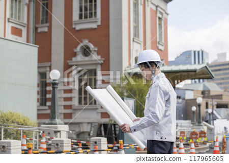 A man in work clothes working at the site 117965605