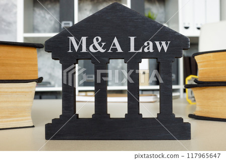 Mergers and acquisitions law sign on office desk. Corporate restructuring concept. Mergers and acquisitions law sign on office desk. Corporate restructuring concept. 117965647