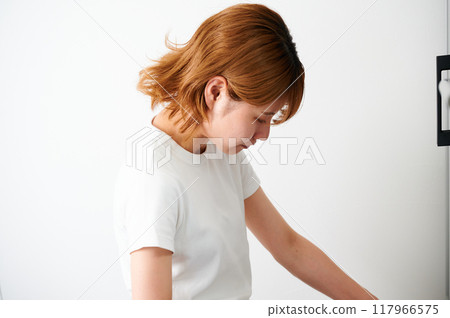 Woman opening cupboard, housewife, housework, cooking, cleaning up 117966575
