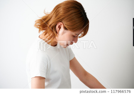 Woman opening cupboard, housewife, housework, cooking, cleaning up Woman opening cupboard, housewife, housework, cooking, cleaning up 117966576