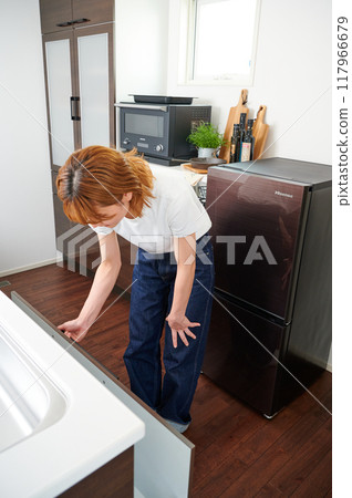 Woman opening cupboard, housewife, housework, cooking, cleaning up Woman opening cupboard, housewife, housework, cooking, cleaning up 117966679