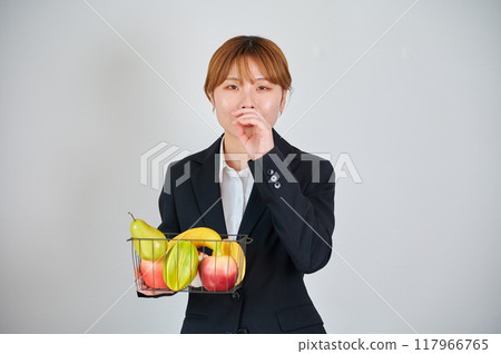 Smiling woman holding fruit Smiling woman holding fruit 117966765