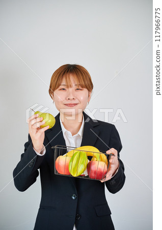 Smiling woman holding fruit 117966775