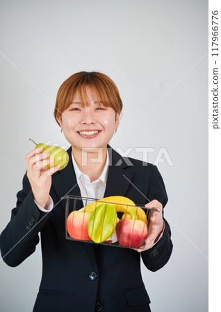 Smiling woman holding fruit 117966776