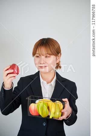 Smiling woman holding fruit 117966788