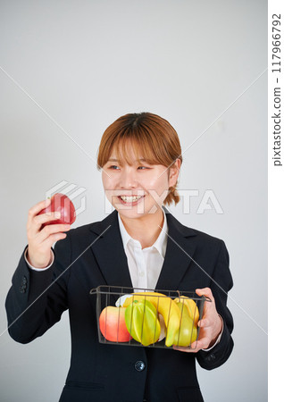 Smiling woman holding fruit Smiling woman holding fruit 117966792