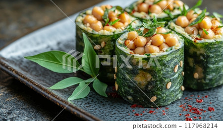 Fresh green sushi rolls filled with chickpeas and garnished with herbs on a dark plate 117968214