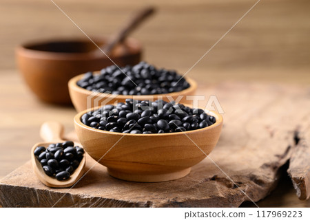 Black bean in bowl with spoon on wooden background, Food ingredient 117969223