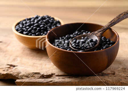 Black bean in bowl with spoon on wooden background, Food ingredient 117969224