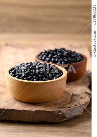 Black bean in bowl on wooden background, Food ingredient 117969225