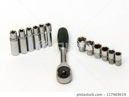 Key ratchet and a set of short and long flare heads. On a white background is Ratchet wrench and union head short and long Key ratchet and a set of short and long flare heads. On a white background is Ratchet wrench and union head short and long 117969619