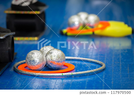 Circus or gymnastic training props balls and hoops on a wooden floor. Circus or gymnastic training props balls and hoops on a wooden floor. 117970500