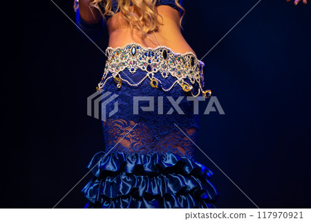 Belly dance. Part of a girl's body dressed in an oriental dance costume. 117970921