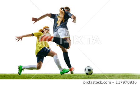 Athletic women, focused and competitive, racing towards ball on green turf, each striving to gain upper hand in game. 117970936