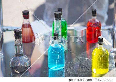 Transparent laboratory flask with multi-colored liquid or chemical solution. 117970992