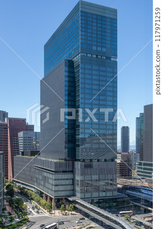 The exterior of JP Tower Osaka (KITTE Osaka) on a clear day, located on the former site of the Osaka Central Post Office, directly connected to JR Osaka Station. Next to Umeda Station 117971259