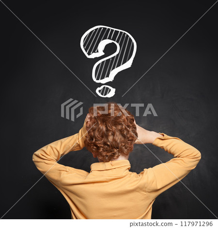 Frightened kid school student and question mark on blackboard. Idea and Education concept Frightened kid school student and question mark on blackboard. Idea and Education concept 117971296