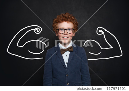 Portrait of smart redhead kid boy with drawn muscles. Success, creative and business concept 117971301