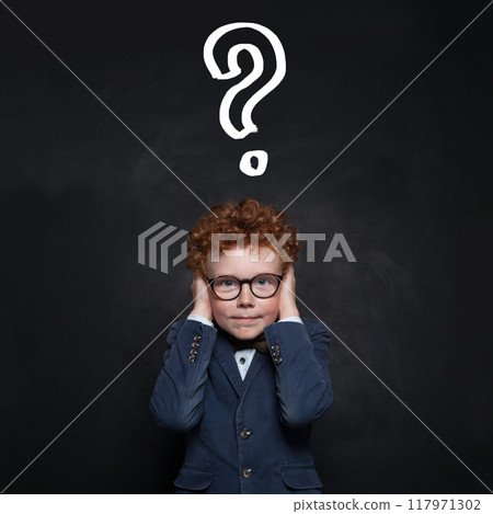 Young school student boy covering his ears with his hands and looking at camera Young school student boy covering his ears with his hands and looking at camera 117971302